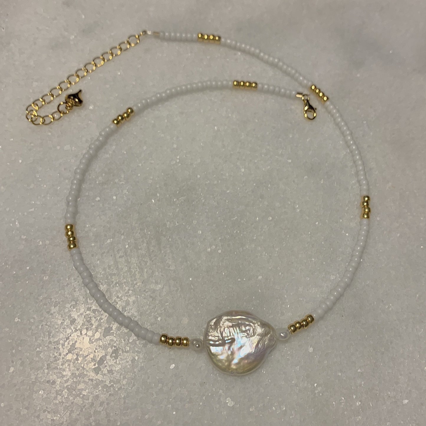 gold and white glass seed bead necklace with freshwater pearl and coin pearl and gold finishes