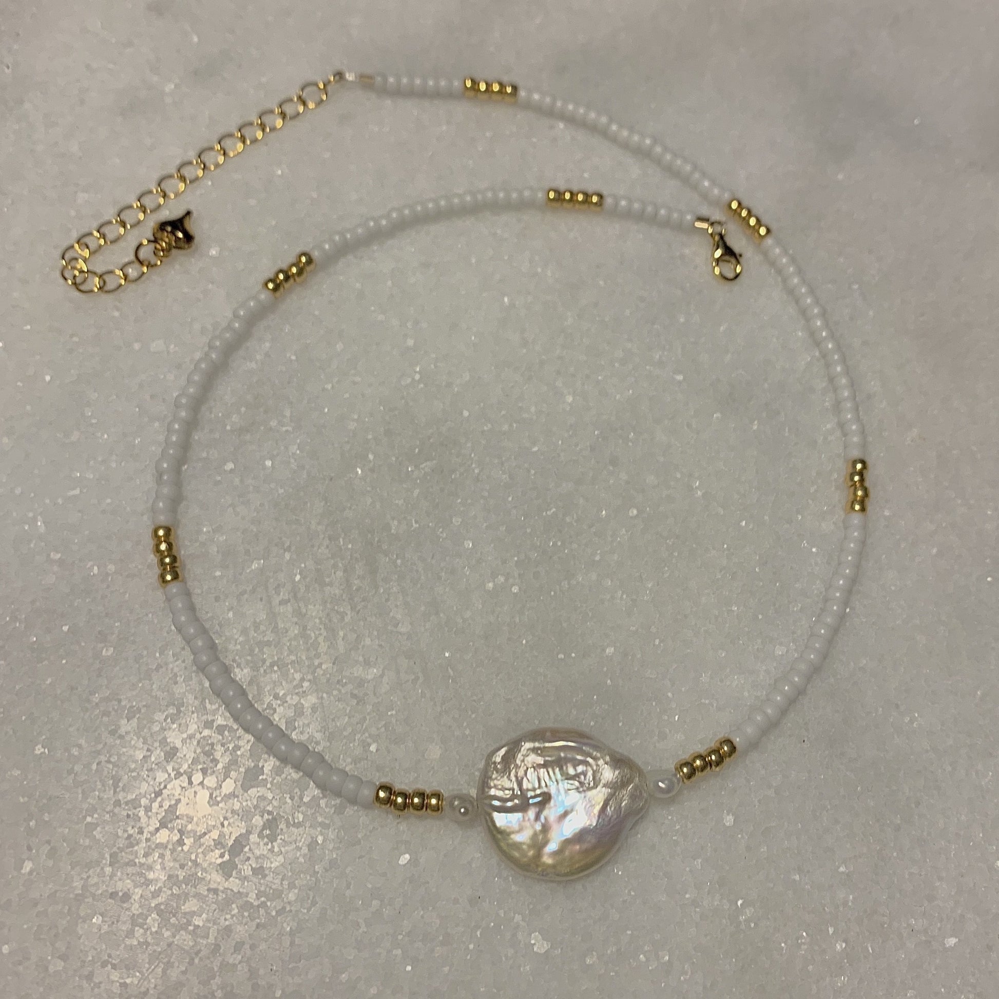 gold and white glass seed bead necklace with freshwater pearl and coin pearl and gold finishes